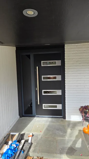 Modern dark entry door with four glass panels
