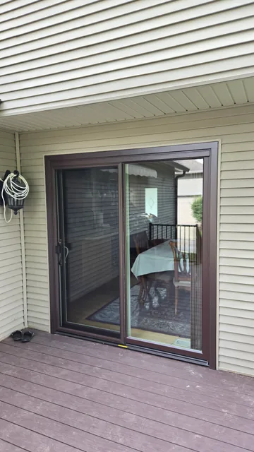 Sliding glass patio door opening onto a deck