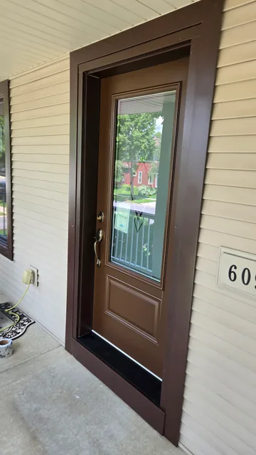 Wood-tone entry door with decorative glass